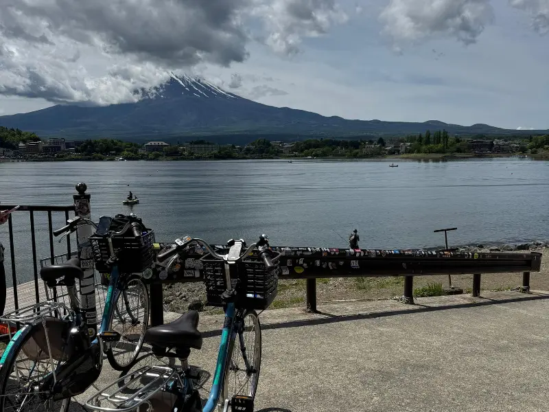 Bicycles parked near Lake Kawaguchiko with Mount Fuji in background