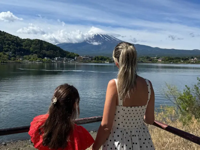 Mother and daughter looking at Mount Fuji from Lake Kawaguchiko shore